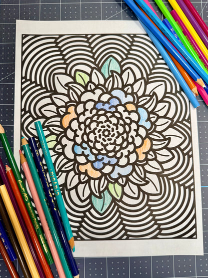 Coloring page with a mandala design surrounded by colored pencils on a grid background